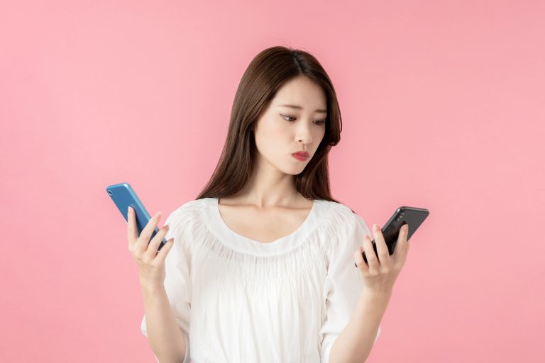 スマホを比べる女性